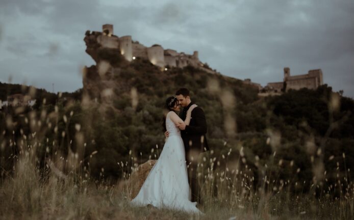 Couple eloping in field at Roccascalegna Castle