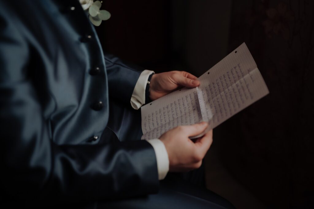 Groom reading his wedding vows during his preparation at home