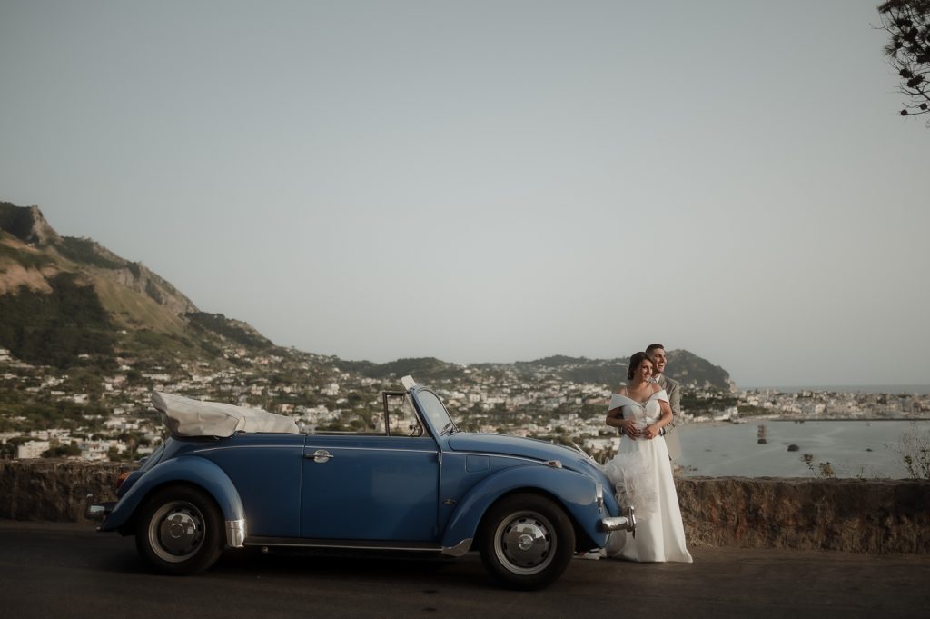 Bride and groom close to an old vintage car for their Capri Wedding in Italy | Elopement Definition