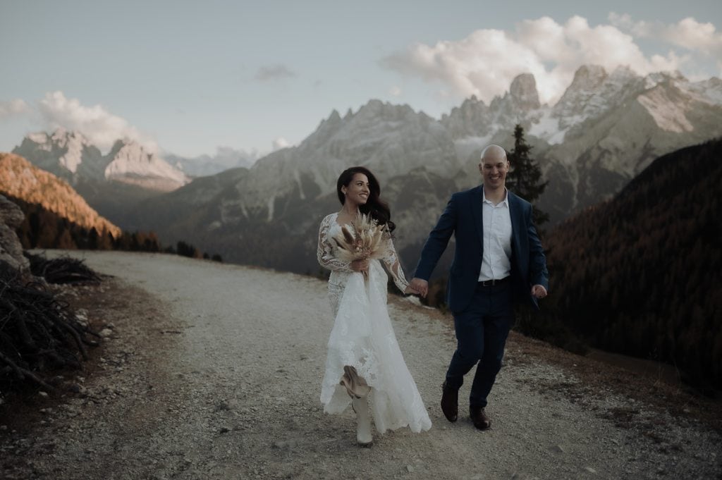 Couple running at sunset during their Dolomites Elopement in Italy
