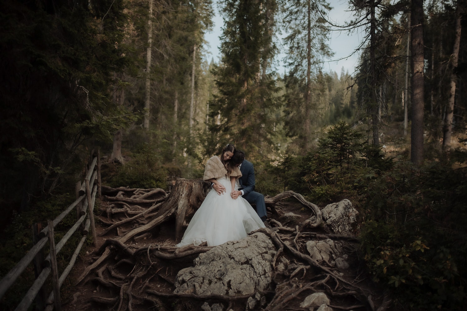 Groom huggin bride in the forest in the Dolomites during Italy Elopement