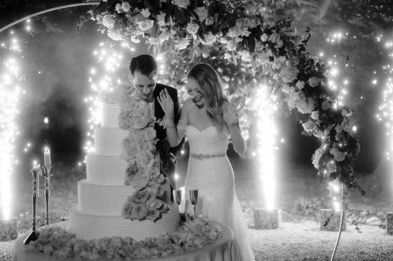 Bride and groom cutting cake with sparkles at Villa Esengrini Montalbano Wedding