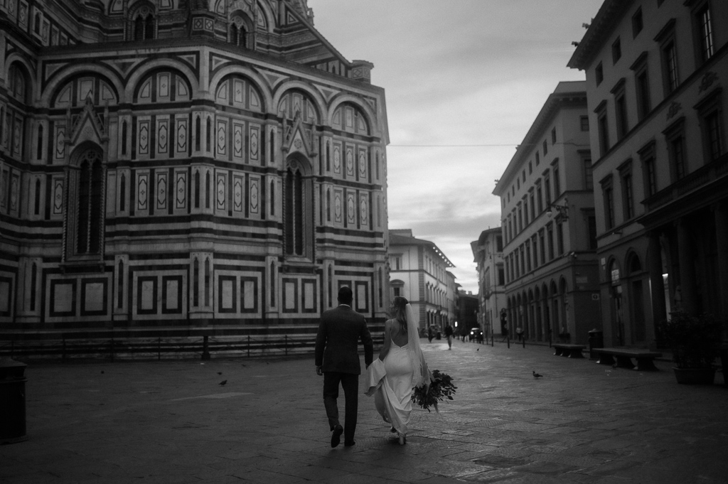 Bride and groom walking at sunrise in Florence during Tuscany Elopement Guide