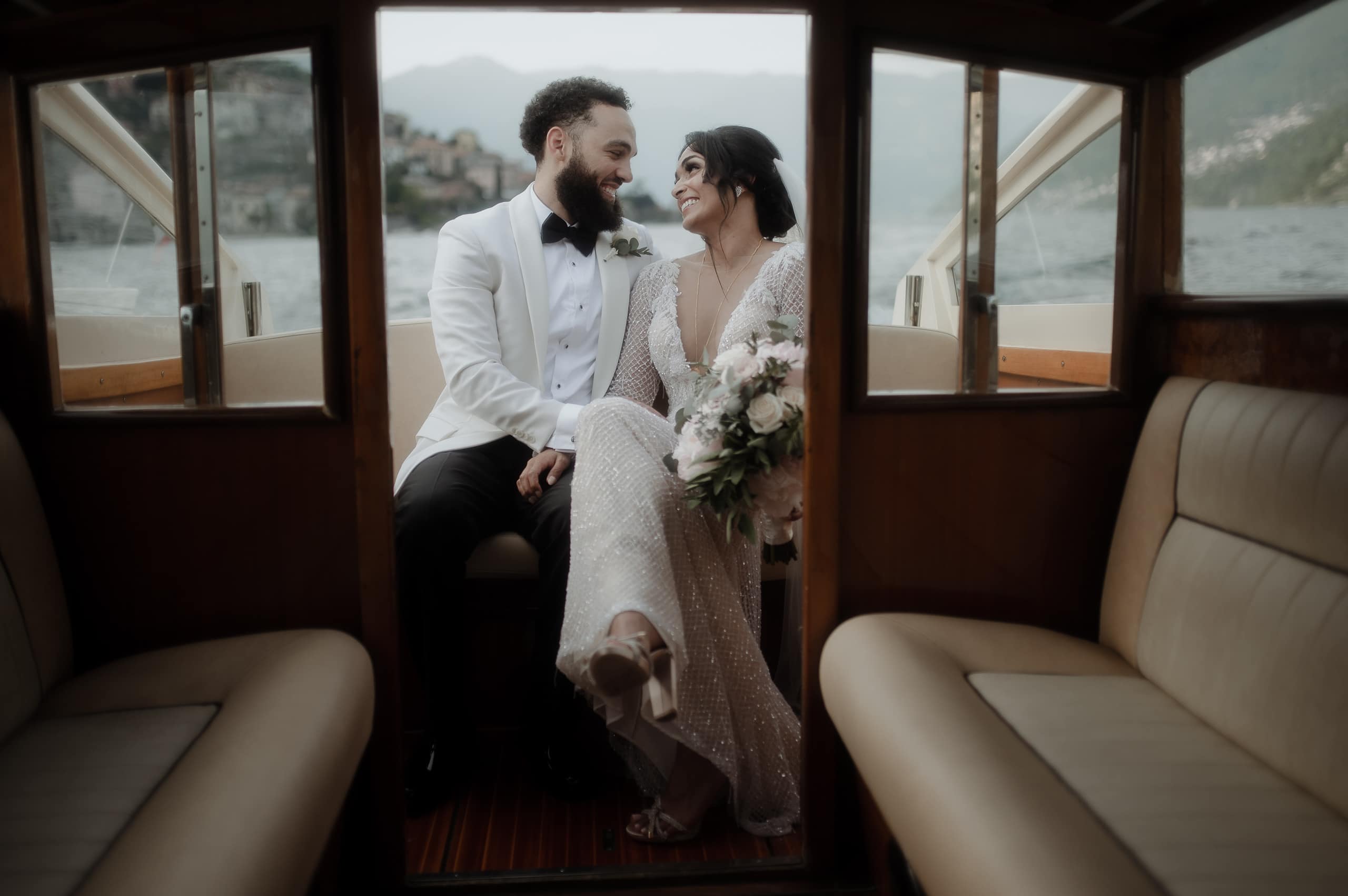 Spouses on boat during Villa Regina Teodolinda Wedding in Lake Como