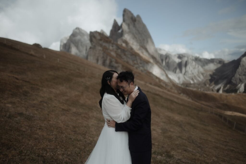 bride and groom hugging and smiling during dolomites seceda elopement