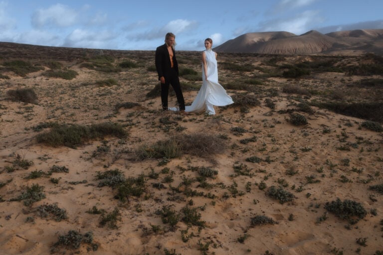 Bride and Groom walking in the desert of La Graciosa for their Lanzarote Elopement